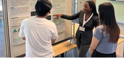 Nelanne Bolima from the University of Maryland Baltimore County (UMBC) shares the results of her project during the REM poster session. 