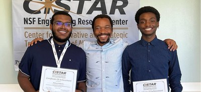 Michael Roberts from Tuskegee University and Keylin Boyd from Texas Christian University with Professor Cornelius Masuku.