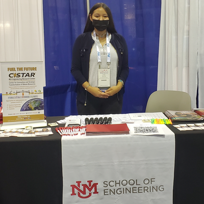 CISTAR Recruiting; young woman standing in front of booth with NMU School of Engineering sign